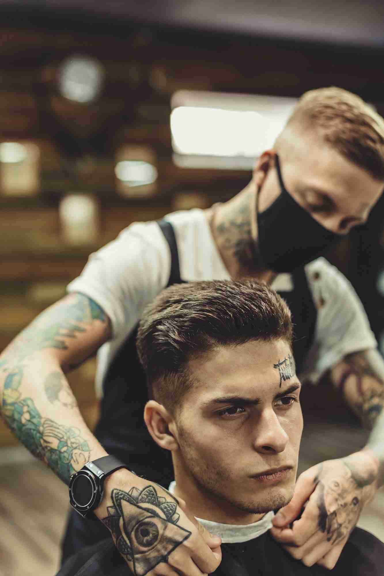 High Class Barber Shop professional preparing a client for a custom haircut.