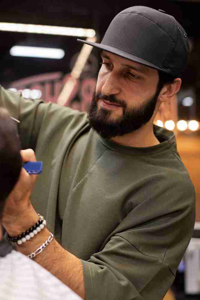Modern classic haircut being performed at High Class Barber Shop.