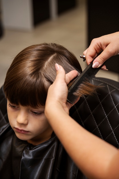 High-angle shot of a child receiving a professional haircut in Anchorage.