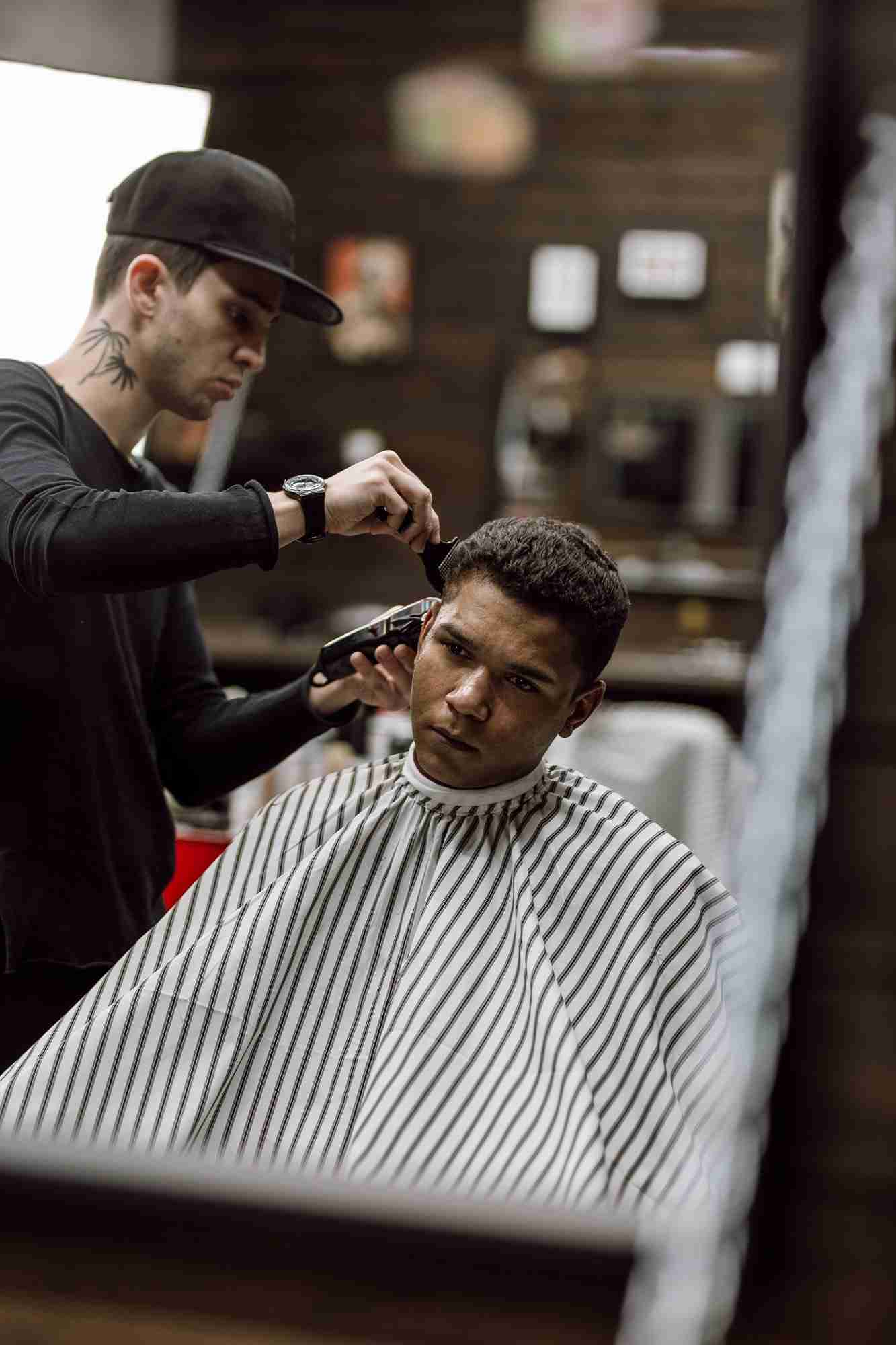 Professional barber performing a precision razor fade at High Class Barber Shop.